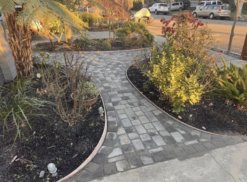 Cobblestone walkway through planting beds